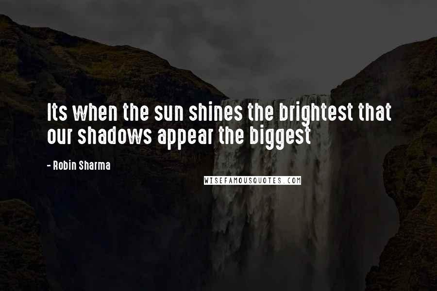 Robin Sharma Quotes: Its when the sun shines the brightest that our shadows appear the biggest