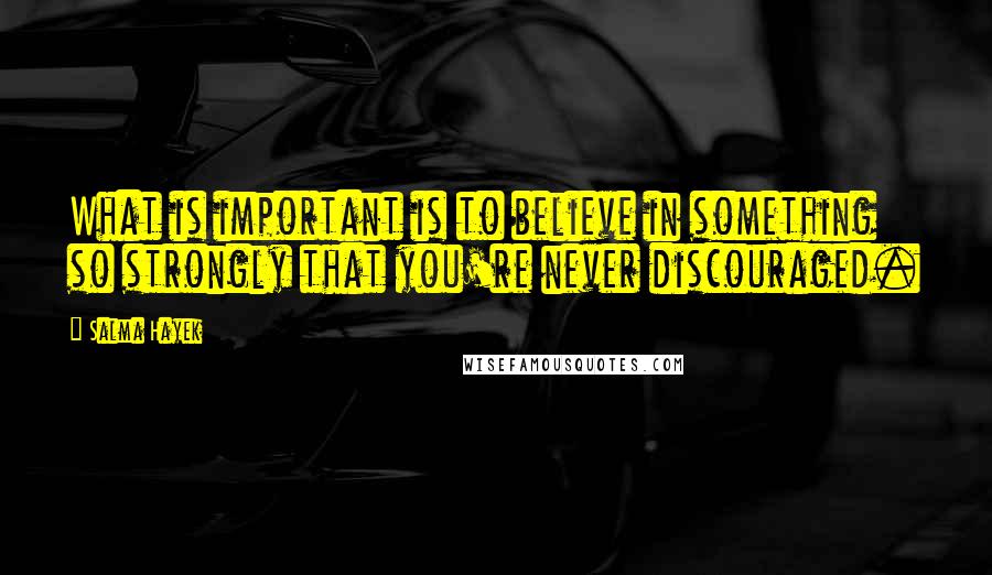 Salma Hayek Quotes: What is important is to believe in something so strongly that you're never discouraged.