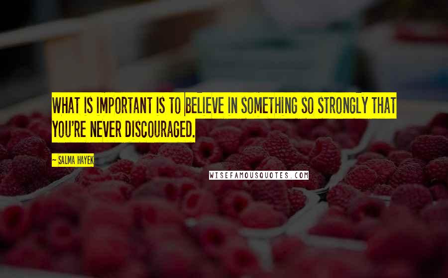 Salma Hayek Quotes: What is important is to believe in something so strongly that you're never discouraged.