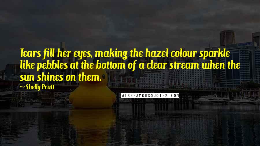 Shelly Pratt Quotes: Tears fill her eyes, making the hazel colour sparkle like pebbles at the bottom of a clear stream when the sun shines on them.