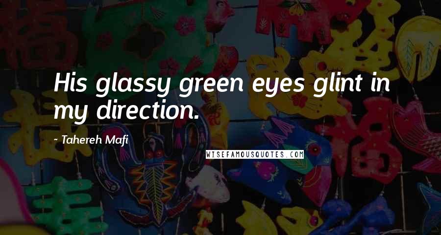 Tahereh Mafi Quotes: His glassy green eyes glint in my direction.