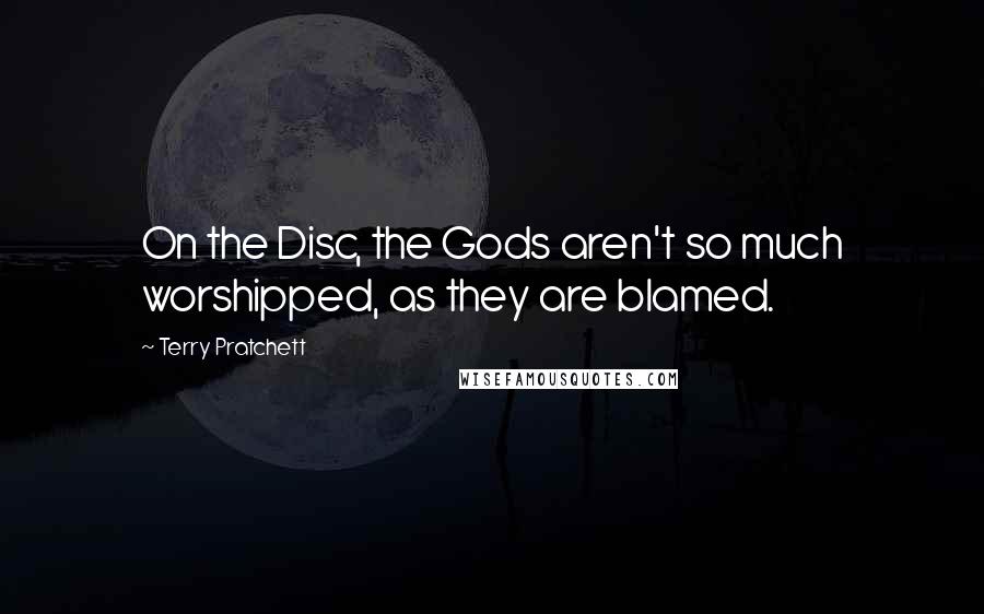 Terry Pratchett Quotes: On the Disc, the Gods aren't so much worshipped, as they are blamed.