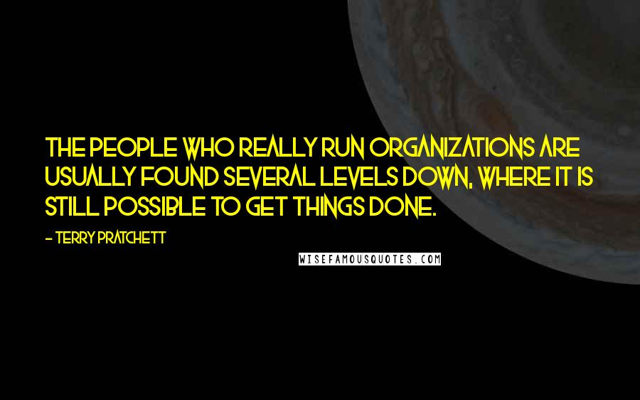 Terry Pratchett Quotes: The people who really run organizations are usually found several levels down, where it is still possible to get things done.
