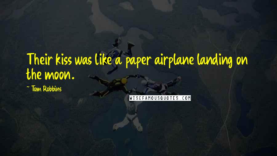 Tom Robbins Quotes: Their kiss was like a paper airplane landing on the moon.