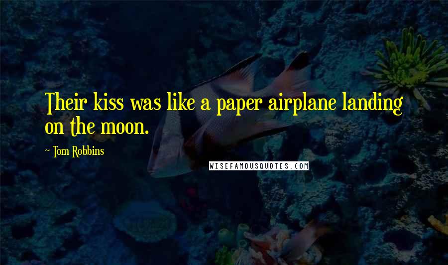 Tom Robbins Quotes: Their kiss was like a paper airplane landing on the moon.