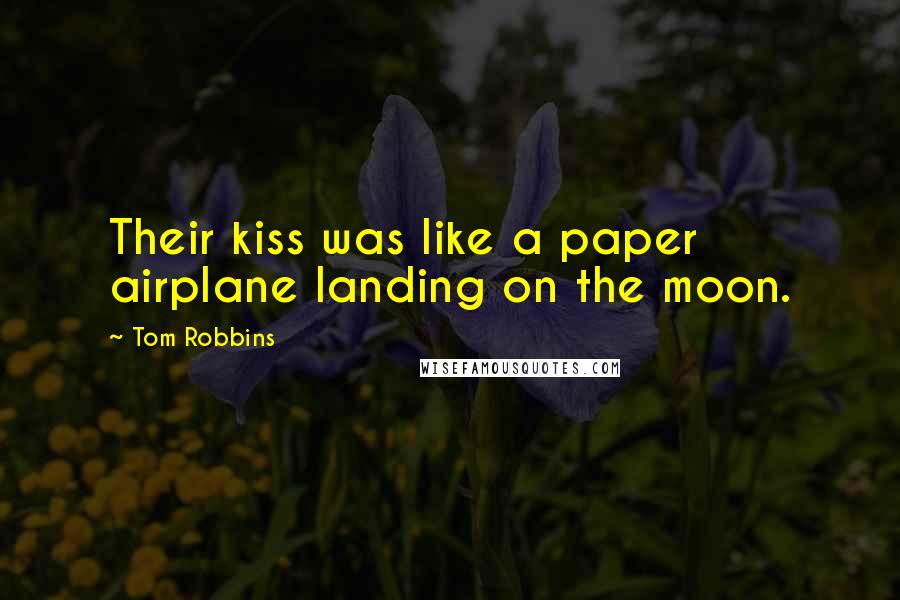 Tom Robbins Quotes: Their kiss was like a paper airplane landing on the moon.