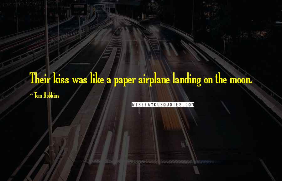 Tom Robbins Quotes: Their kiss was like a paper airplane landing on the moon.