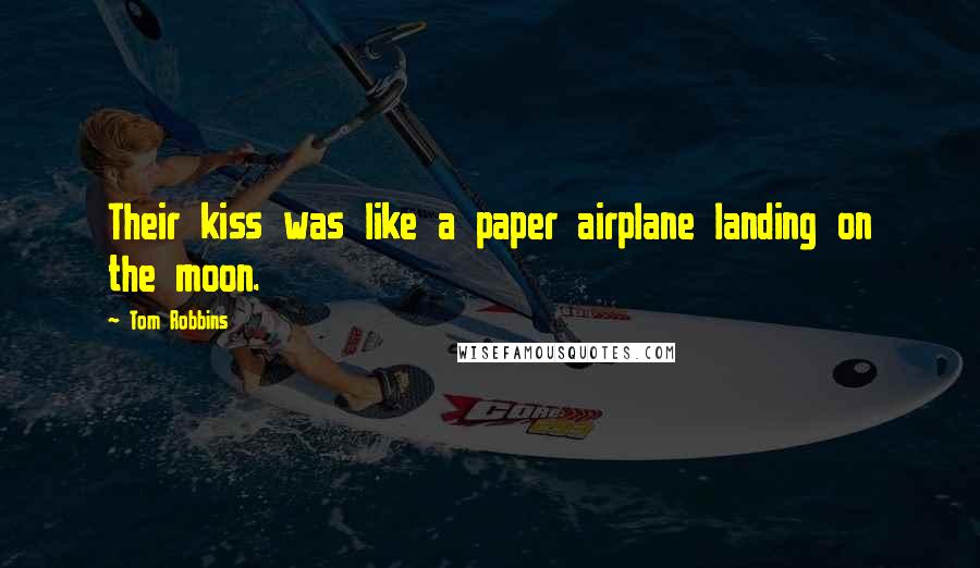 Tom Robbins Quotes: Their kiss was like a paper airplane landing on the moon.