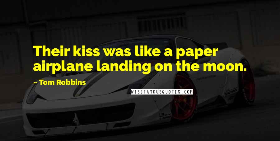 Tom Robbins Quotes: Their kiss was like a paper airplane landing on the moon.