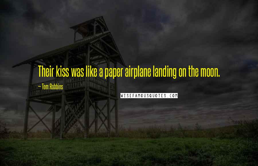 Tom Robbins Quotes: Their kiss was like a paper airplane landing on the moon.