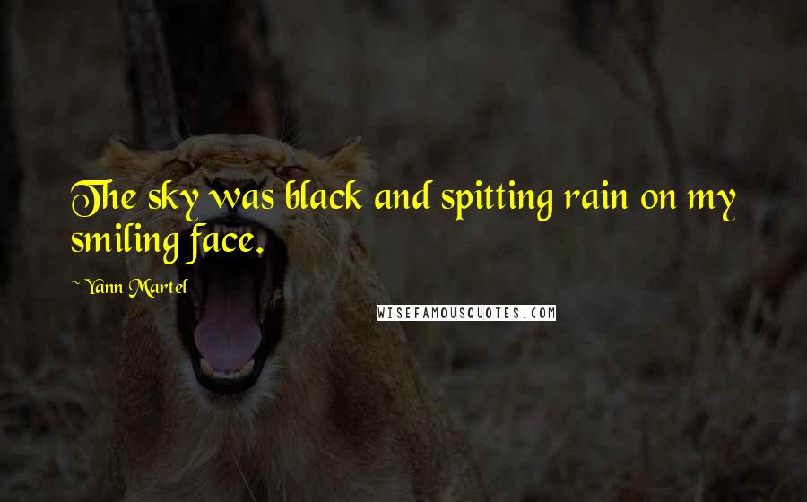 Yann Martel Quotes: The sky was black and spitting rain on my smiling face.