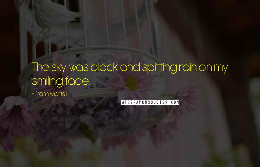 Yann Martel Quotes: The sky was black and spitting rain on my smiling face.